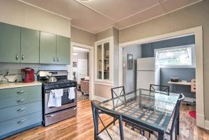 a kitchen with a glass table and a kitchen with a stove at Historic Redstone with Large Backyard, Walk To CSU! in Fort Collins