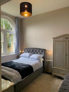 a bedroom with a large bed and a window at A Delightful Historic Torbay Hidden Gem! in Stokeinteignhead