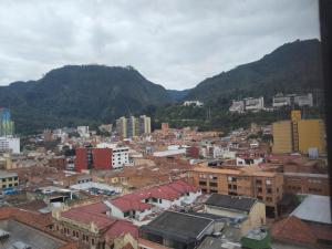 a view of a city with mountains in the background at Habitaciones Centro Histórico in Bogotá