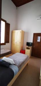 a bedroom with a bed and a desk and a window at Casina Raho B&B in Nardò
