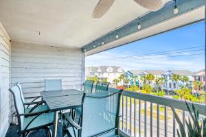 a patio with a table and chairs on a balcony at No Hurry - 302 in Myrtle Beach