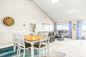 a dining room and living room with a table and chairs at No Hurry - 302 in Myrtle Beach