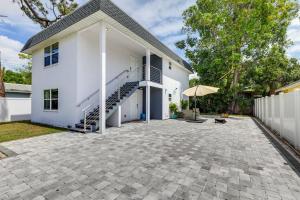 a white house with a patio in front of it at Cozy Sarasota Retreat - 3 Blocks to the Coast! in Sarasota