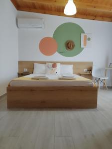 a bedroom with a large bed with a wooden frame at Iris Apartments Ksamil in Ksamil