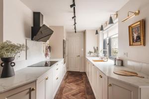 a kitchen with white cabinets and a counter top at Springfield-Windermere in Windermere