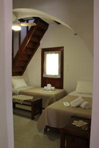 A bed or beds in a room at Evanthea Residence