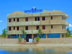 a hotel building with a sign on top of it at Hotel Alba in Torre Lapillo