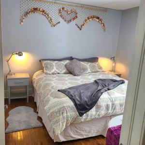 a bedroom with a bed with hearts on the wall at The Sailing Gypsy and Bunkie incl in pricing June 22-Sept 14 in Port Elgin