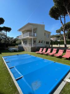 a blue trampoline in front of a house at Costa Brava Villa in Platja  d'Aro