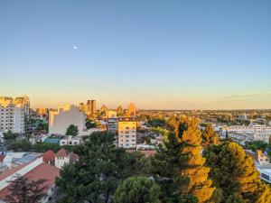an aerial view of a city at sunset at Dolce Casa Departamentos in Neuquén