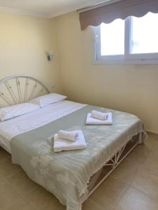 a bedroom with a bed with towels on it at Three Bed villa, Private Pool in Didim