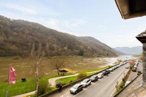 a long line of cars parked next to a river at Haus Blaue Traube mit moselblick in Ediger-Eller
