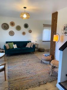 a living room with a blue couch and a rug at Casa da Monservia in Sintra