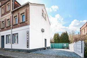 a white building on the side of a street at Anhalt Pension in Coswig