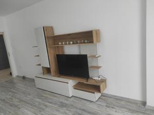a flat screen tv sitting in a entertainment center at Апартамент Памела ВИП гр. Добрич in Dobrich
