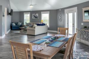 a dining room and living room with a table and chairs at The Sand Dollar in Mexico Beach