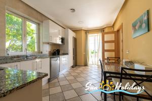 a kitchen with a table and chairs in a room at Villa Oasis in El Vendrell