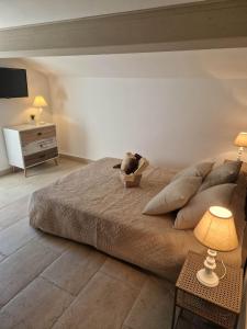 a bedroom with a large bed with a stuffed animal on it at Casa Ditta in Mela