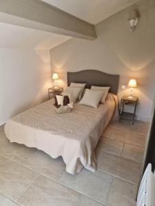a bedroom with a large bed with two lamps at Casa di Mela in Mela