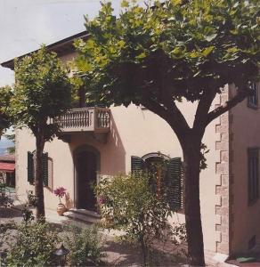 a house with a balcony on the side of it at Hotel Villa Porta All'Arco in Volterra