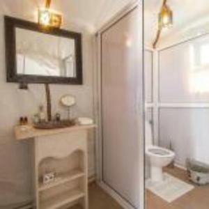 uma casa de banho com uma cabina de duche em vidro e um WC. em Merzouga heart camp em Merzouga