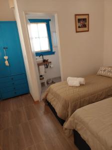 a bedroom with two beds and a blue cabinet at Aristobulo in Buenos Aires