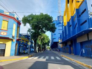 an empty street in a city with colorful buildings at Aristobulo in Buenos Aires