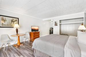 a hotel room with a bed and a table and chairs at FairBridge Inn and Suites West Point in Highland Falls