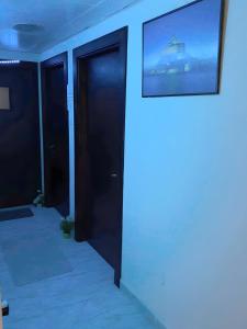 Zimmer mit Tür und Bild an der Wand in der Unterkunft MBZ - Relax Room in Unique Flat in Abu Dhabi