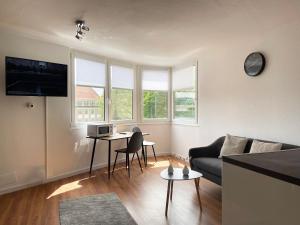 - un salon avec un canapé et une table dans l'établissement Zentral gelegene Studios I home2share, à Osnabrück