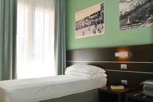 Posteľ alebo postele v izbe v ubytovaní Hotel Vienna