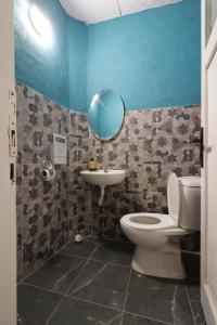 a bathroom with a toilet and a sink at Gold Coast Hostel in Antalya