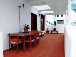 a dining room with a wooden table and chairs at Casa Jasmin Haria in Haría +14 photos
