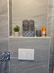 a shelf with two rings on it in a bathroom at A Comfortable and Modern Newly Renovated Apartment in Mannheim