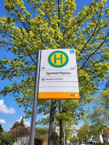 a sign for a supermarket in front of a tree at A Comfortable and Modern Newly Renovated Apartment in Mannheim