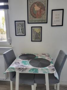 a table with chairs and a table cloth on it at A Comfortable and Modern Newly Renovated Apartment in Mannheim