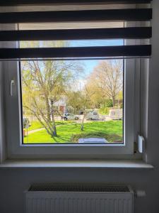 a window with a view of a yard at A Comfortable and Modern Newly Renovated Apartment in Mannheim