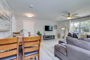 a living room with a table and a couch at Coastal Sarasota Condo Minutes to Beach! in Sarasota