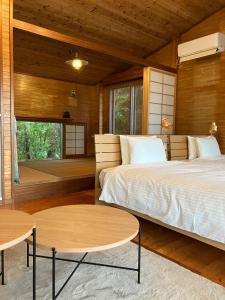 a bedroom with two beds and two tables at Inn Suenaga - Vacation STAY 25965v in Hiji
