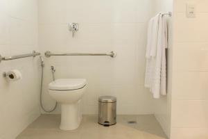 a bathroom with a toilet and a towel at Hotel Real Executive in Aparecida de Goiânia