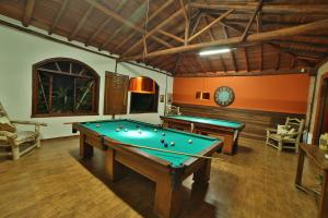 a billiard room with two pool tables in it at Leão de Judá Charme Hotel in São Sebastião do Paraíso