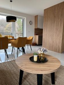 a living room with a table with flowers on it at Apartmán s vyhliadkou in Bojnice