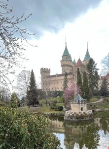 a large building with a pond in front of it at Apartmán s vyhliadkou in Bojnice