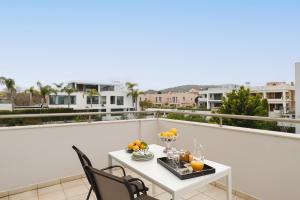 a balcony with a table with fruit on it at Marilena Mare Seaside & Jacuzzi House 50meters from sea in Ialysos +30 photos