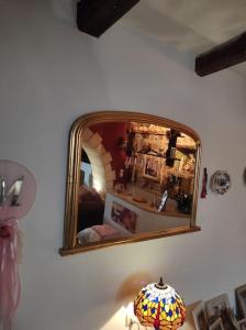 a mirror on a wall above a table with a lamp at Semina-Marina in Hersonissos