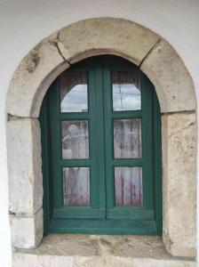 a green window in a building with an arch at Semina-Marina in Hersonissos