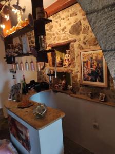 a kitchen with a counter and a stone wall at Semina-Marina in Hersonissos