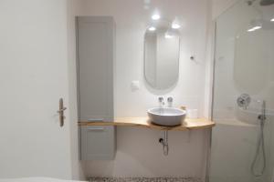a bathroom with a sink and a shower at Patio Apartment near metro & Acropolis in Athens