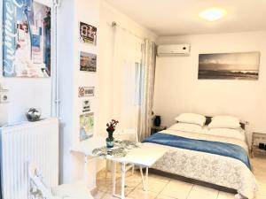 アテネにあるMon apartment Alkionis Palaio Faliroの小さなベッドルーム(ベッド1台、テーブル付)