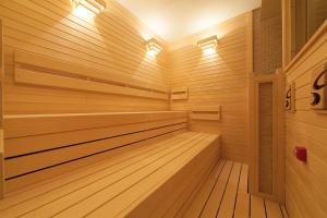 a sauna with wooden paneling and lights at Sakura Terrace The Gallery in Kyoto